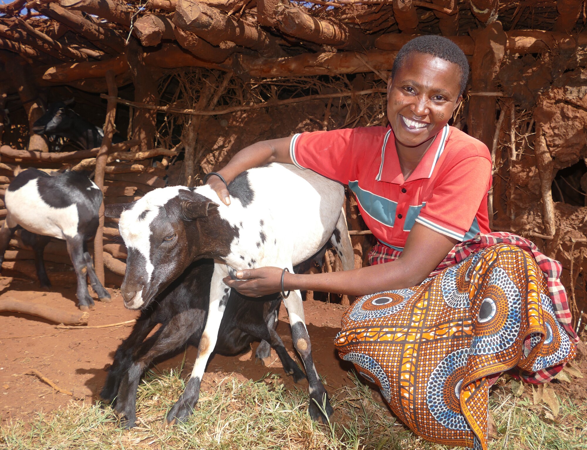 Selina Paulo with one of the goats she financed with money she got from selling chickens. Paulo has seven goats at her farm in Gidamunyara village, Hanang district, Tanzania.