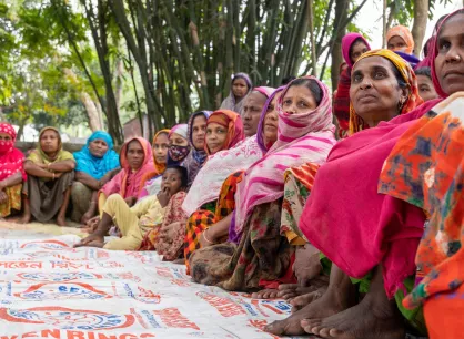 RS114162_CO2A9817-lpr.jpg A group of Bangladeshi women sit on a mat outside