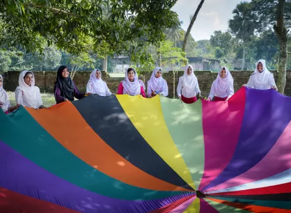 Girls play with a parachute