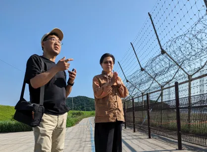 Mennonite Central Committee (MCC) Northeast Asia representative SeongHan Kim, left, and Gyodong Island peace worker Kim Young-Ae are on the South Korean island’s shore, about a mile from North Korea