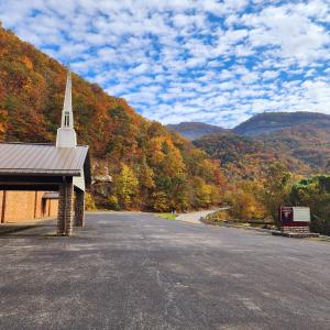 A church with a beautiful fall mountain backdrop