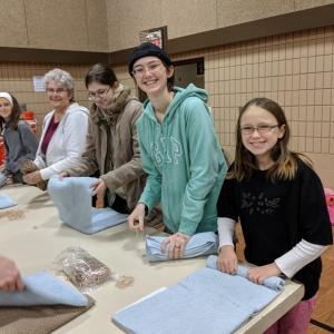 A group of people packing relief kits