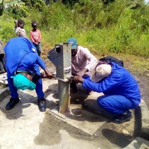 A group of men installing a well