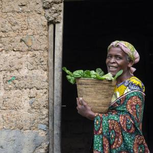 A woman holding a basket of fresh food