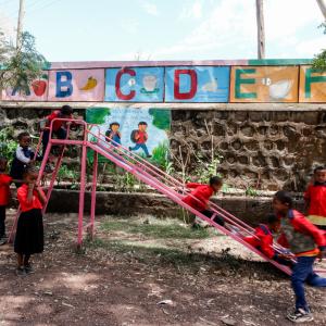 Children playing on a slide at a playground