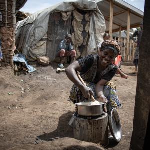 A woman stirring food in a pot