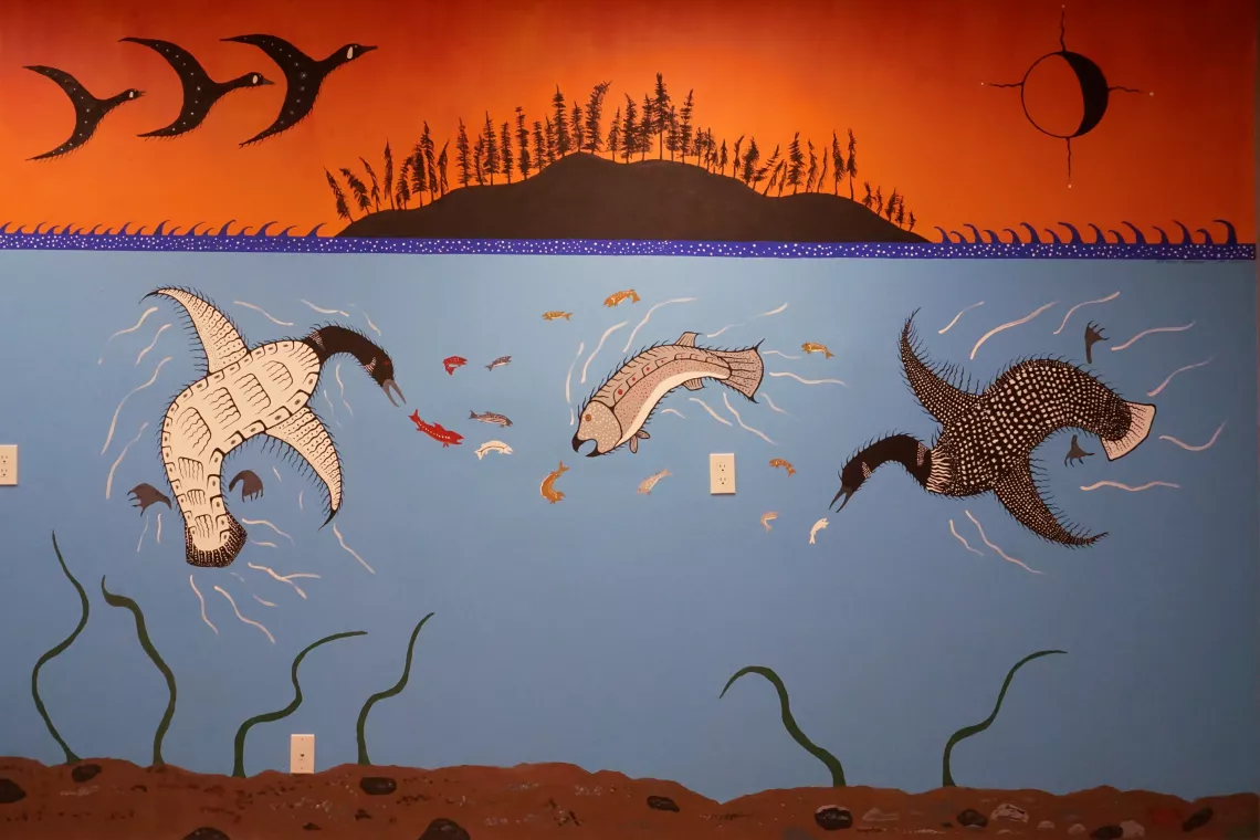 Mural depicting waterfowl and fish under a red sky.