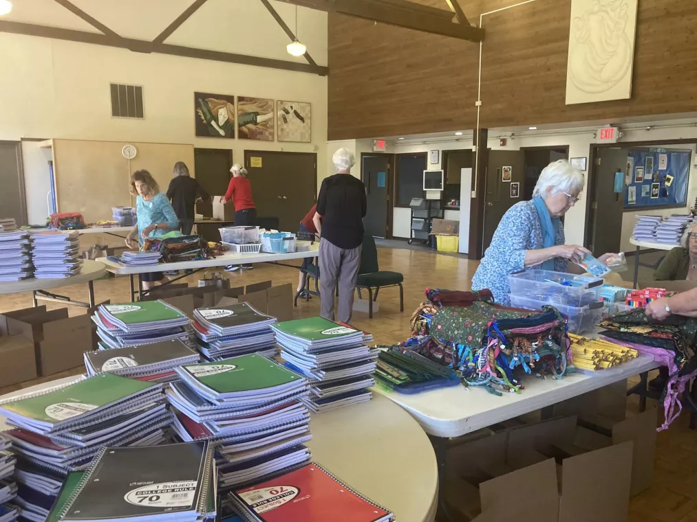 Church members pack school kits for MCC's School Kit Challenge.