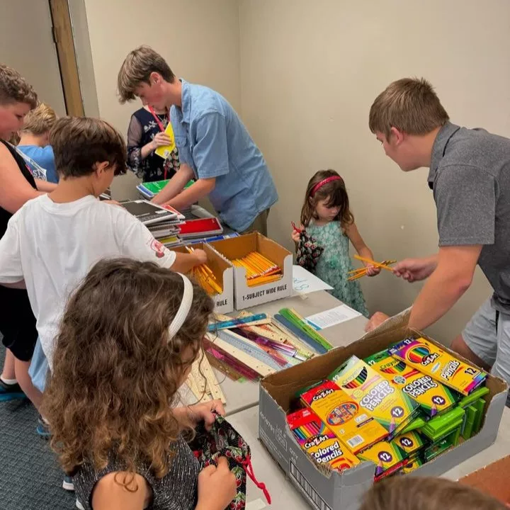 Members from a church pack school kits for MCC's School Kit Challenge.
