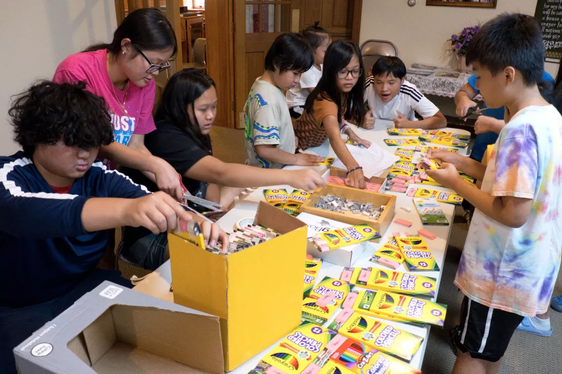 Members from a church pack school kits for MCC's School Kit Challenge.