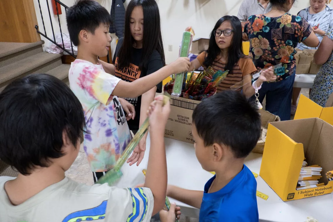 Members from a church pack school kits for MCC's School Kit Challenge.