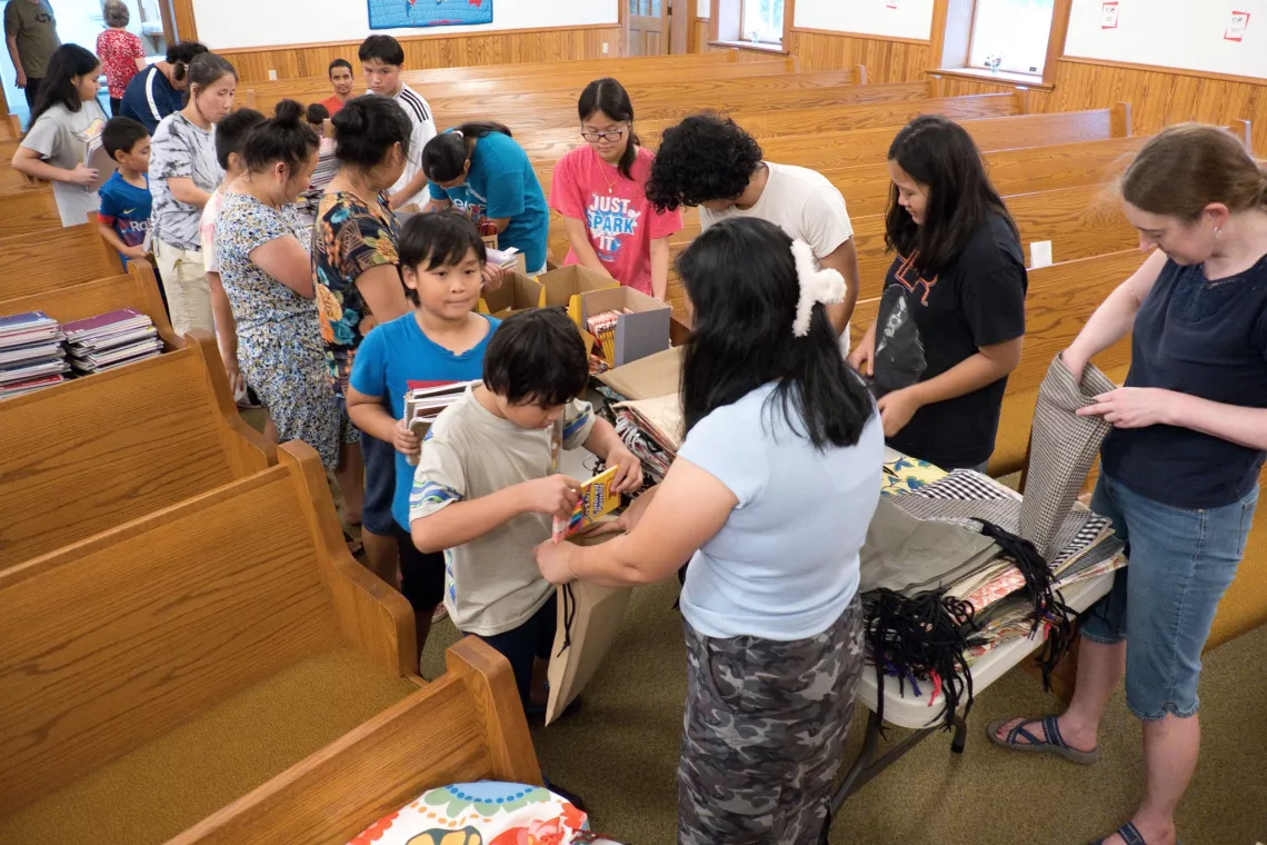 Members from a church pack school kits for MCC's School Kit Challenge.