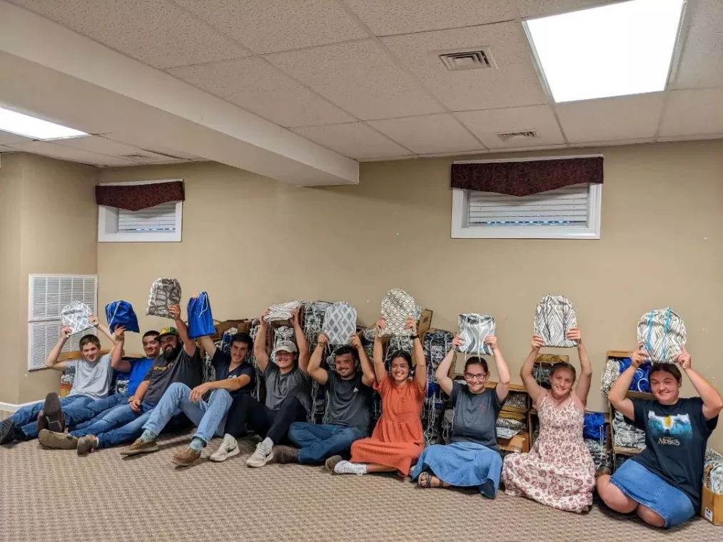 Members from a church pack school kits for MCC's School Kit Challenge.