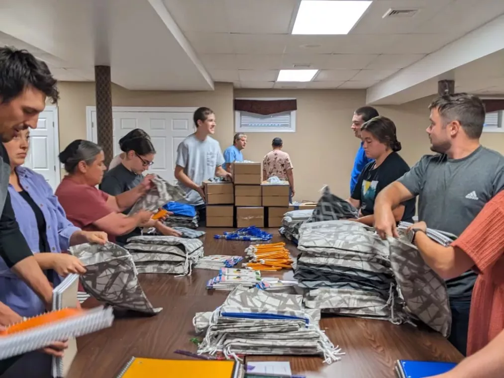 Members from a church pack school kits for MCC's School Kit Challenge.