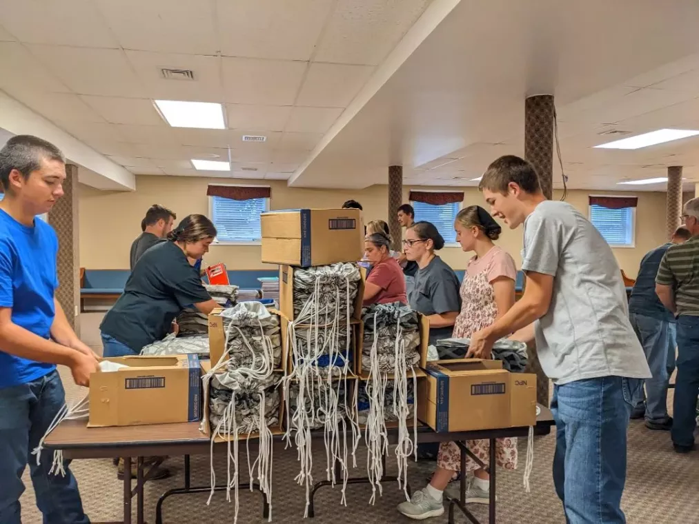 Members from a church pack school kits for MCC's School Kit Challenge.