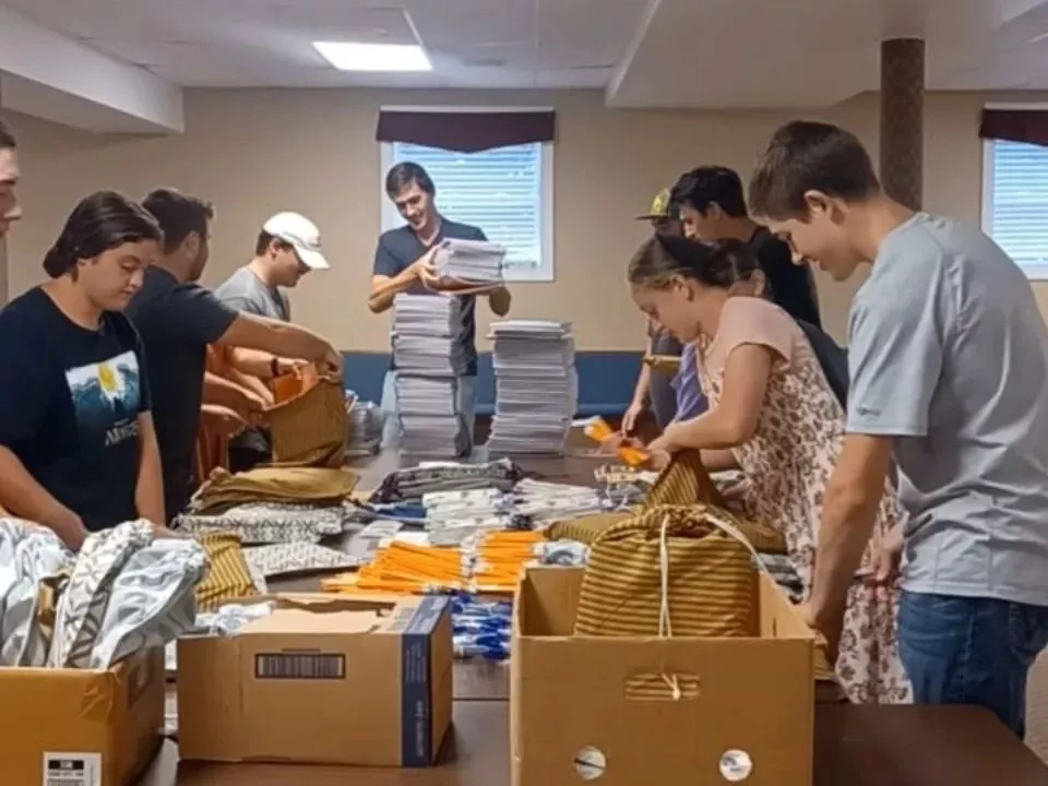 Members from a church pack school kits for MCC's School Kit Challenge.