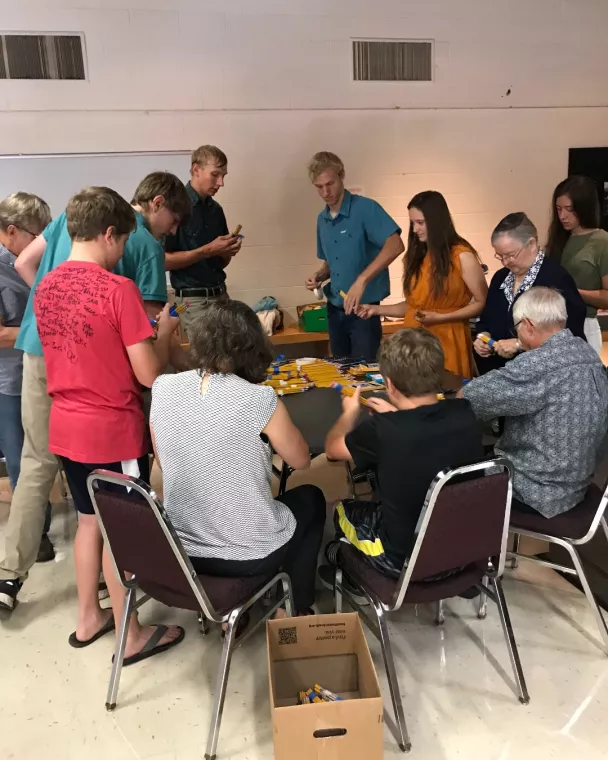 Members from a church pack school kits for MCC's School Kit Challenge.