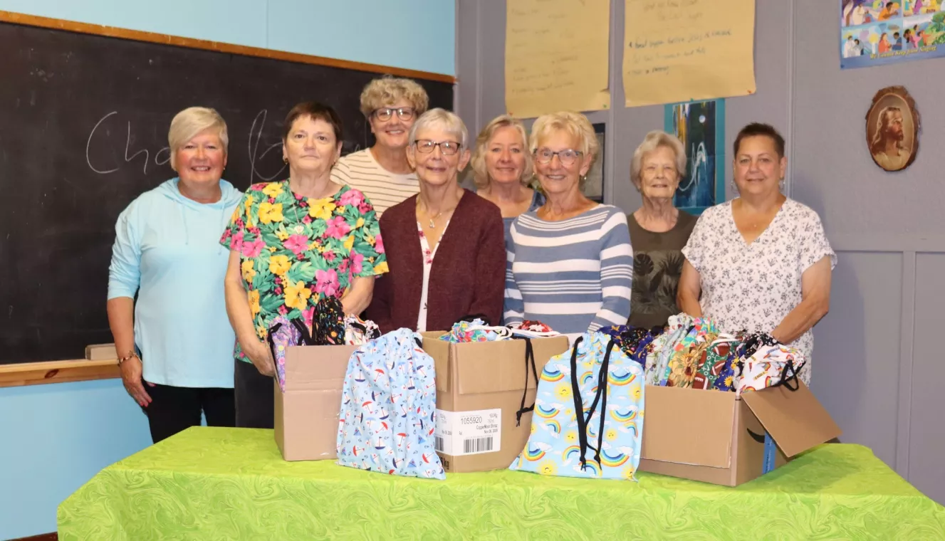 Members from a church pack school kits for MCC's School Kit Challenge.