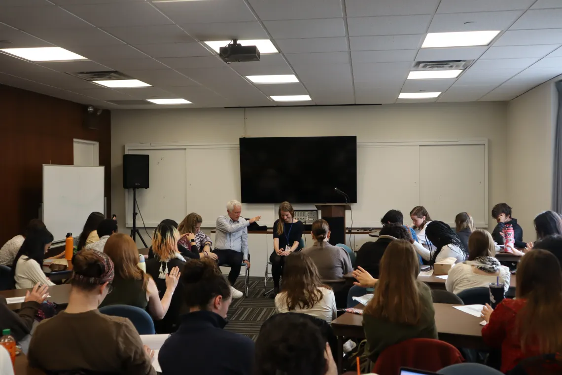 Group of students pray for a U.S. diplomat. 