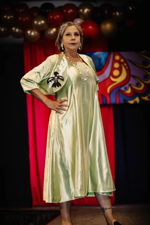  A woman models an Indigenous designed evening wear outfit.