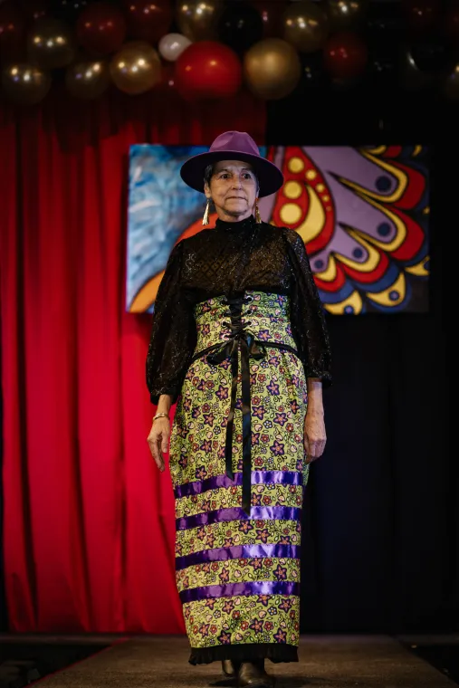 A woman models an Indigenous designed outfit.