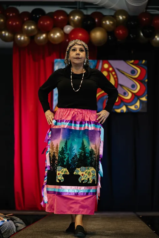 A woman models an Indigenous-designed skirt.