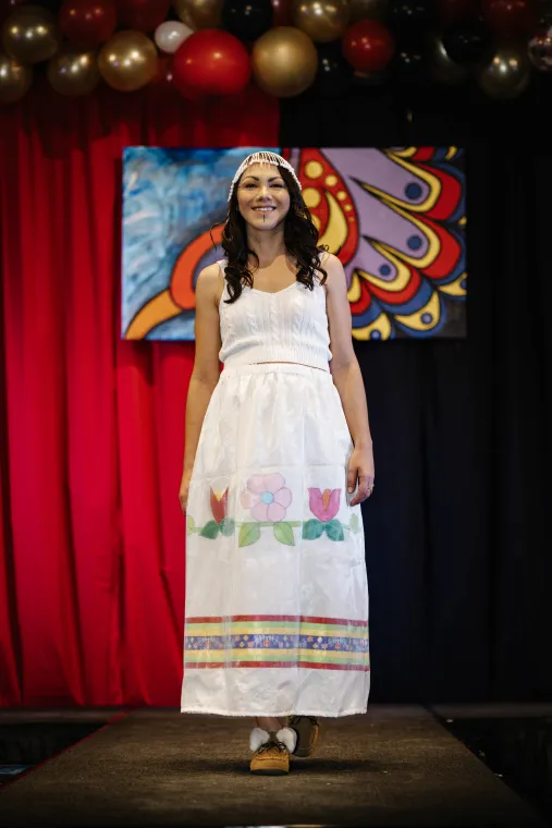 A young woman models an Indigenous-designed skirt.