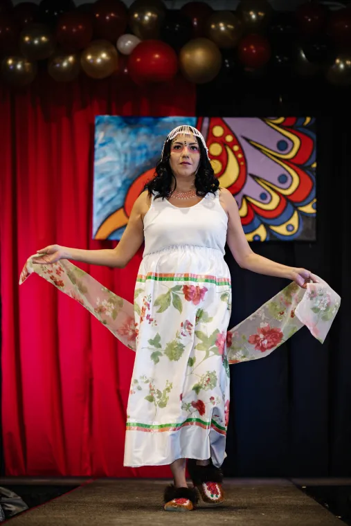 A woman models an Indigenous-designed outfit.