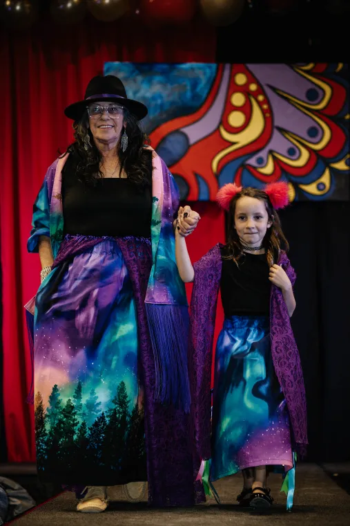 A woman and young child model matched Indigenous designed outfits.