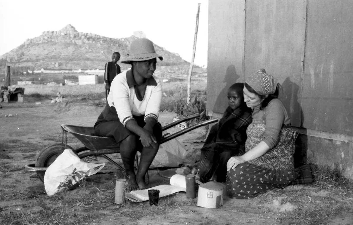 Women sitting on the ground.