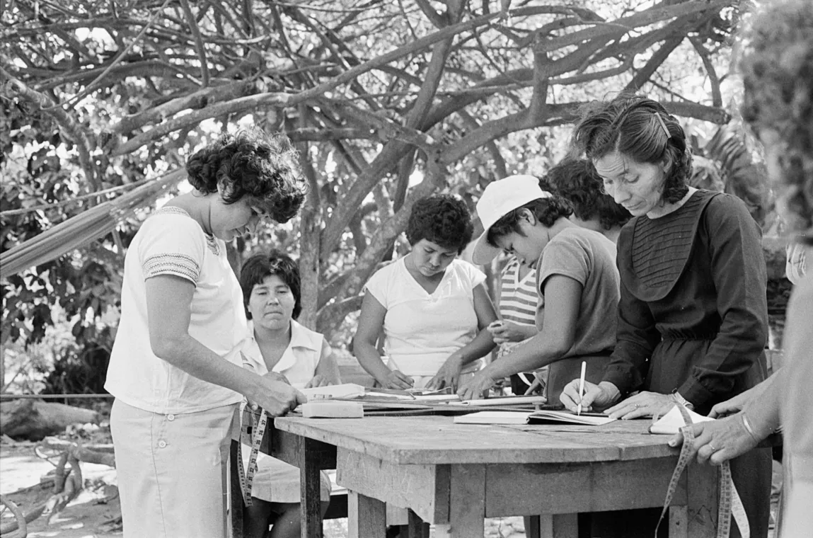 Group of women writing on a table
