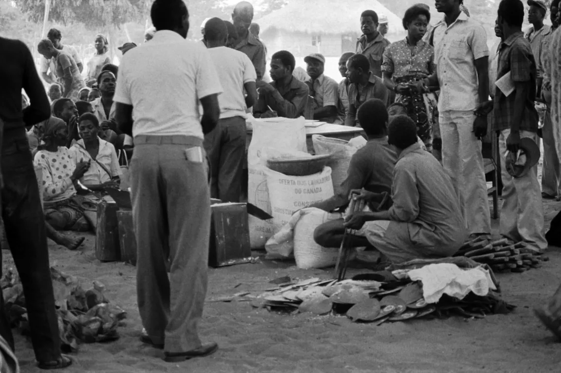 Group of people distributing corn.