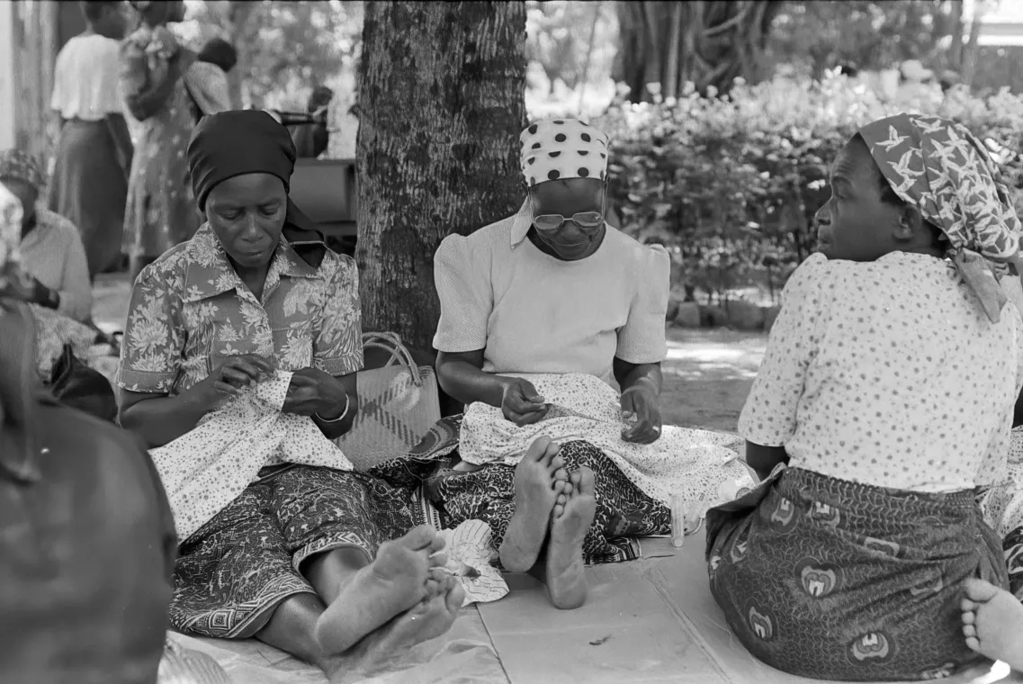 A group of women sewing.