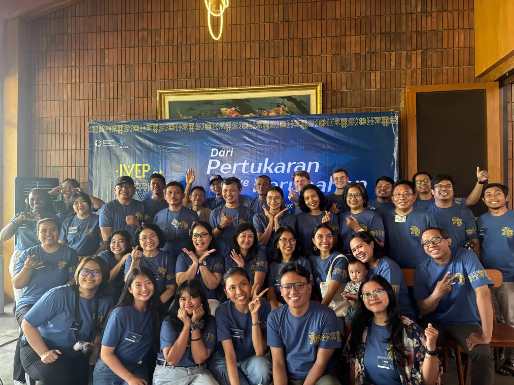 Group photo in front of a blue sign