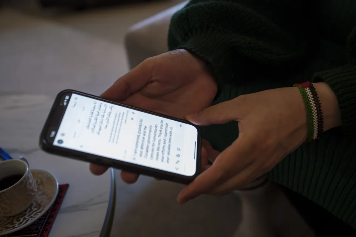 Hands holding a phone being used to translate a conversation