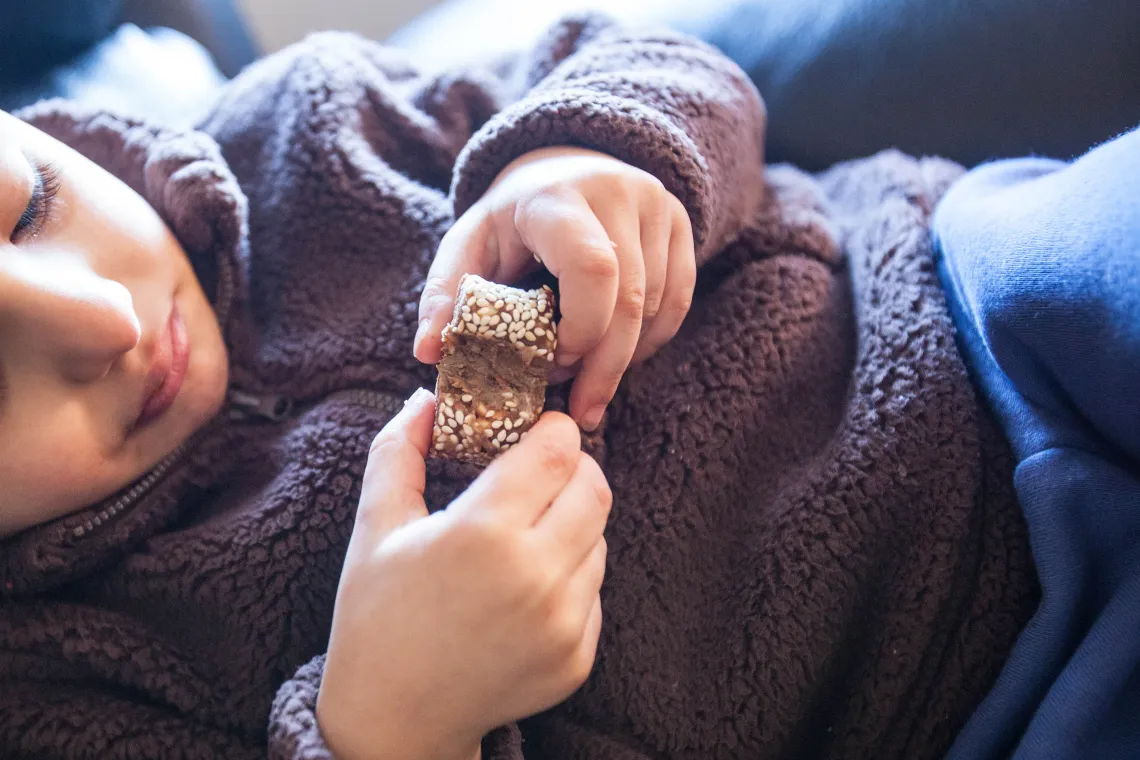 A child eats a homemade sweet in their home