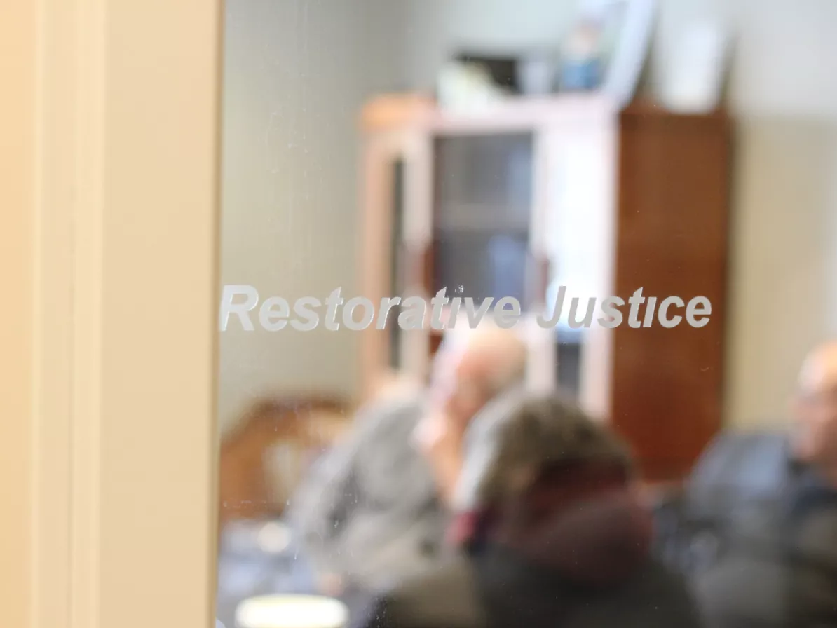 A glass office door that says "restorative justice"