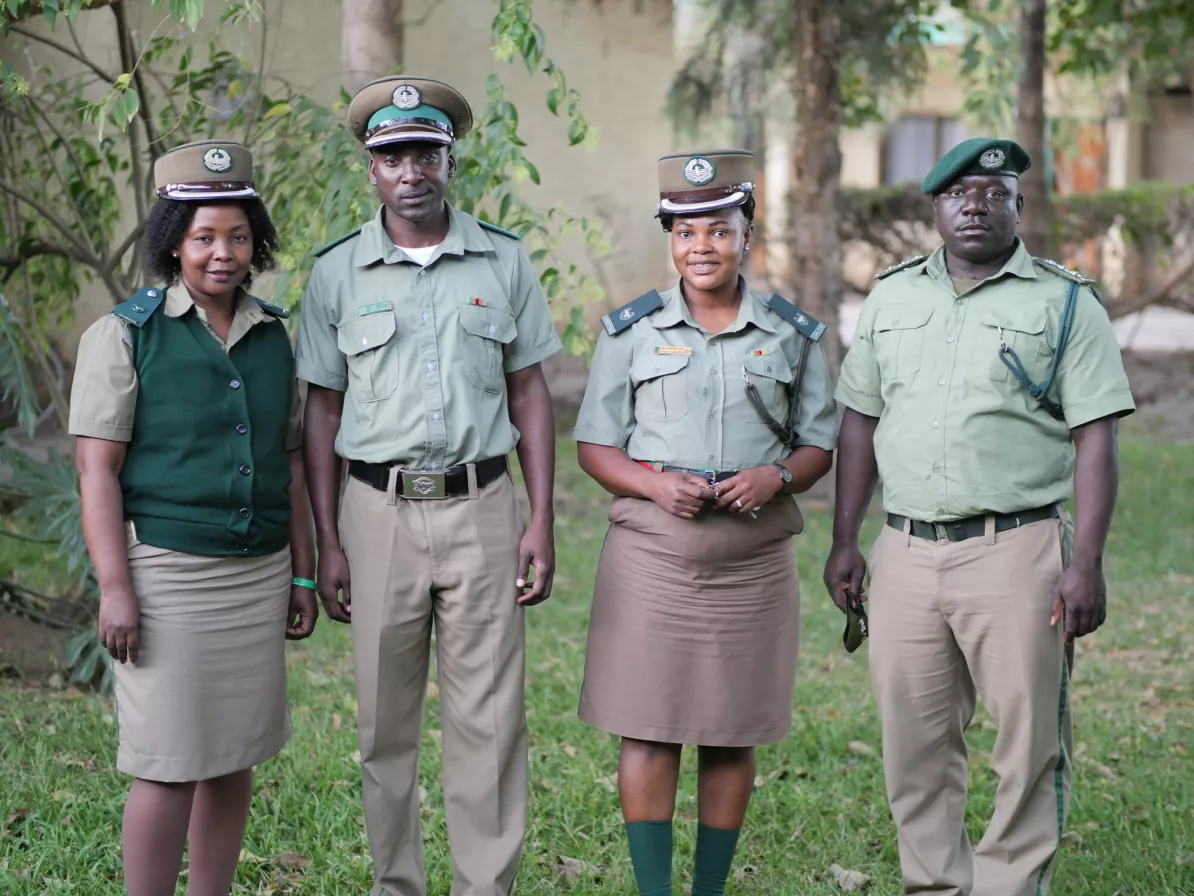 Four people wearing police uniforms