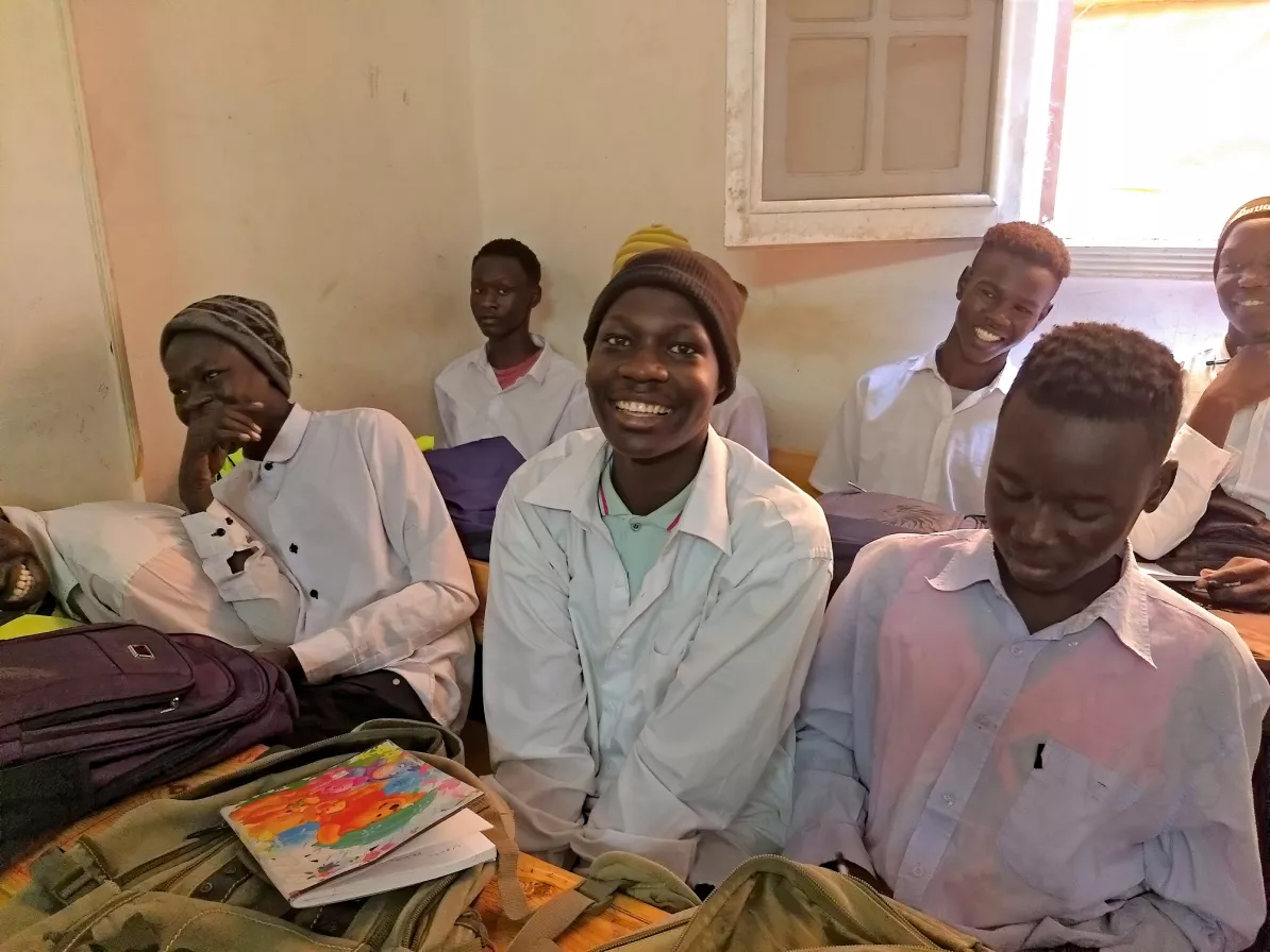 Several Sudanese students sit in a classroom
