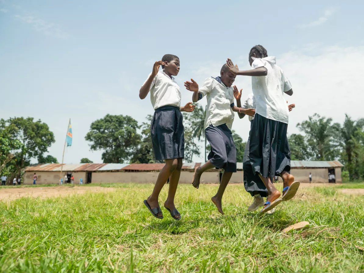 Children jumping and playing in a school yard
