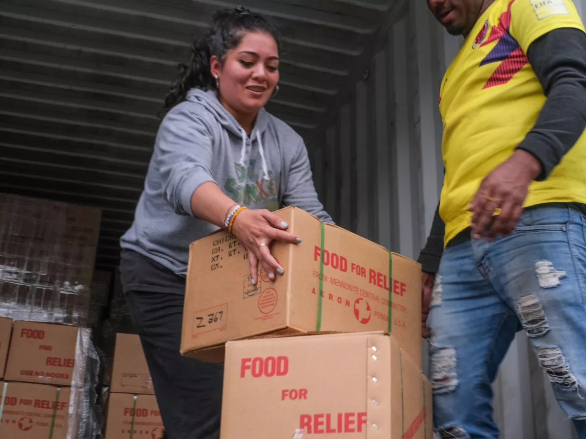 A woman loading boxes of relief supplies