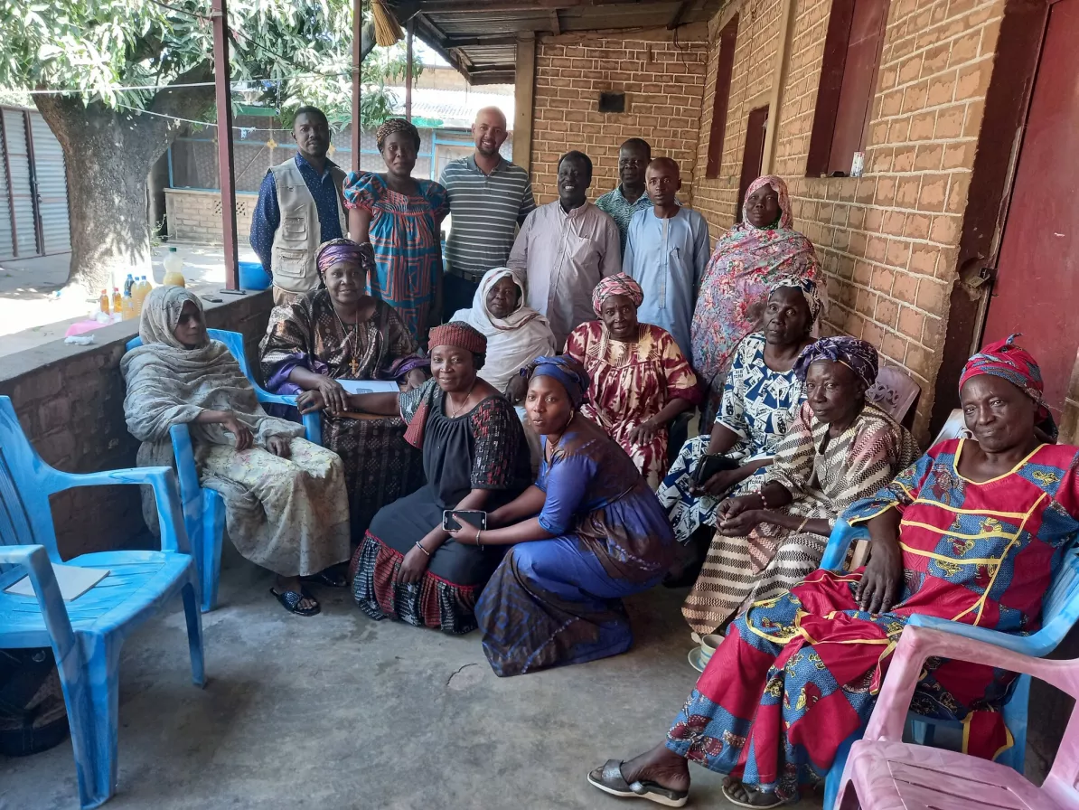 A group of Chadian people sit and stand for a group photo