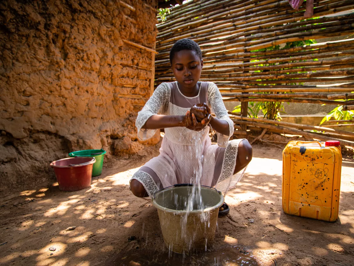 A woman washing clothes with water