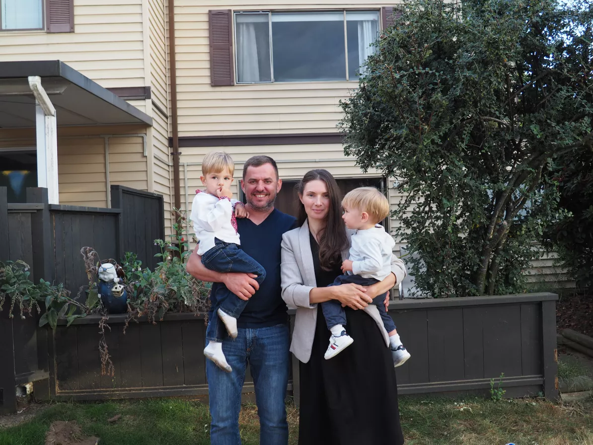 A man and woman holding two children