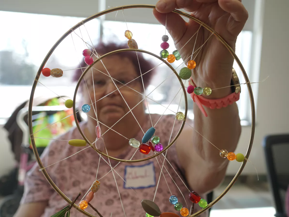 A woman holding a dream catcher