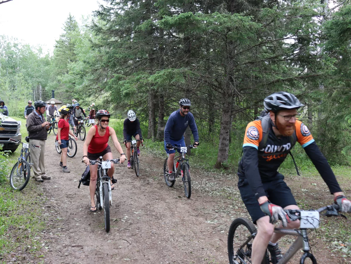 A group of people riding mountain bikes