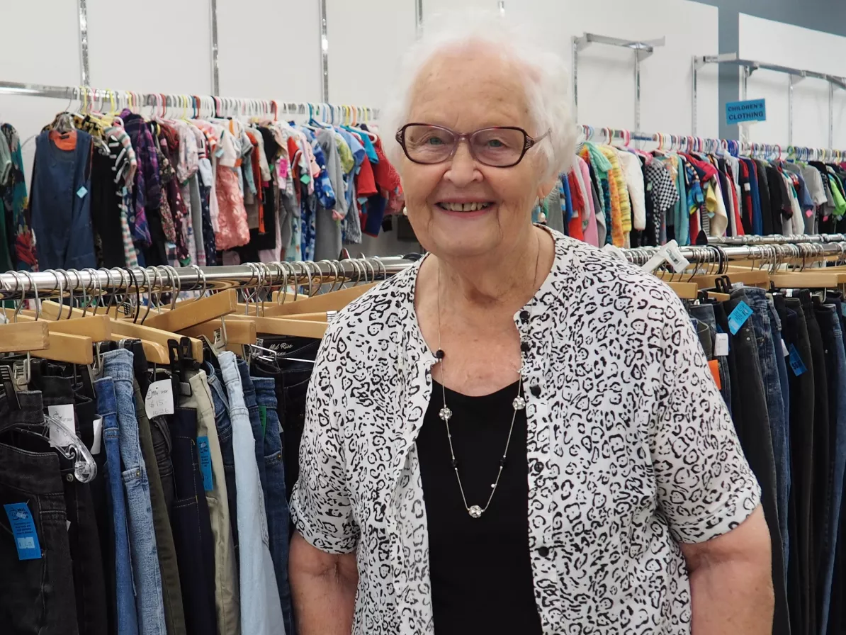 A woman standing in a thrift shop