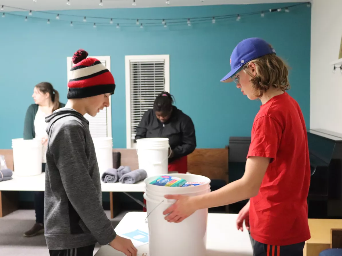 Two young people packing relief kits