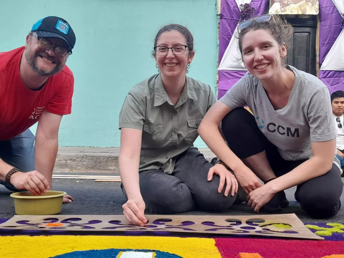 Three people smiling for a photo