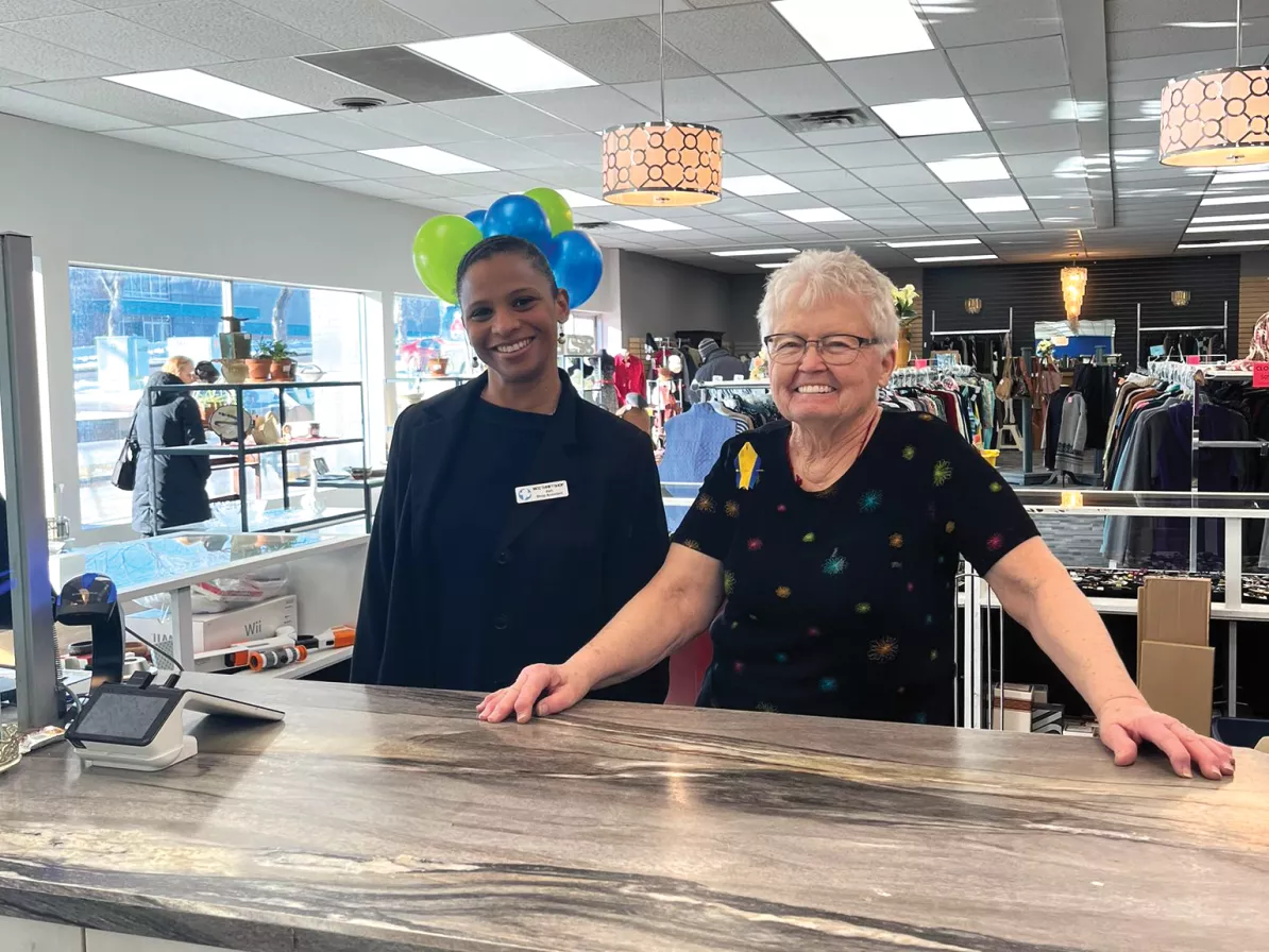 Two women standing in a thrift shop